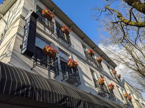 The historic Camas Hotel on NE 4th Avenue in downtown Camas, Washington, with flower baskets under its windows